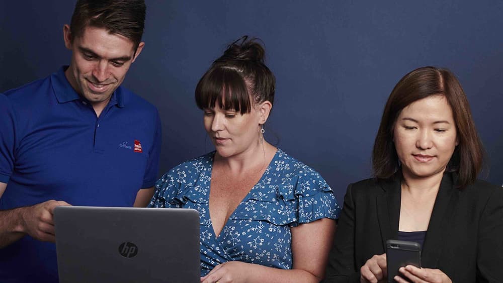 Three people checking their devices